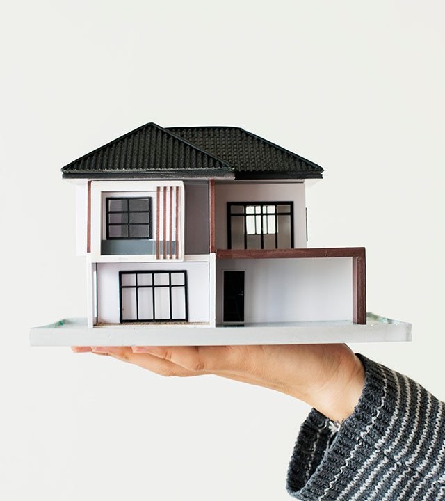 Hand presenting model house for home loan campaign